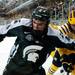 Michigan State freshman Travis Walsh and Michigan senior defenseman Lee Moffie compete for the puck in the second period on Friday. Daniel Brenner I AnnArbor.com